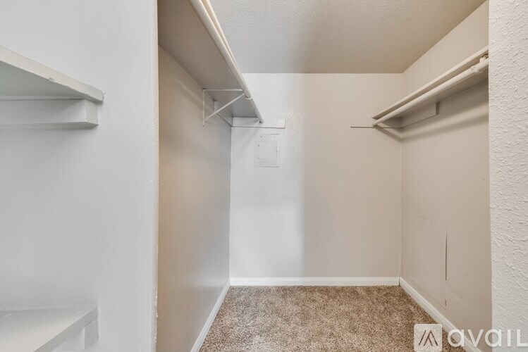 A small, empty room with a carpeted floor and white walls.