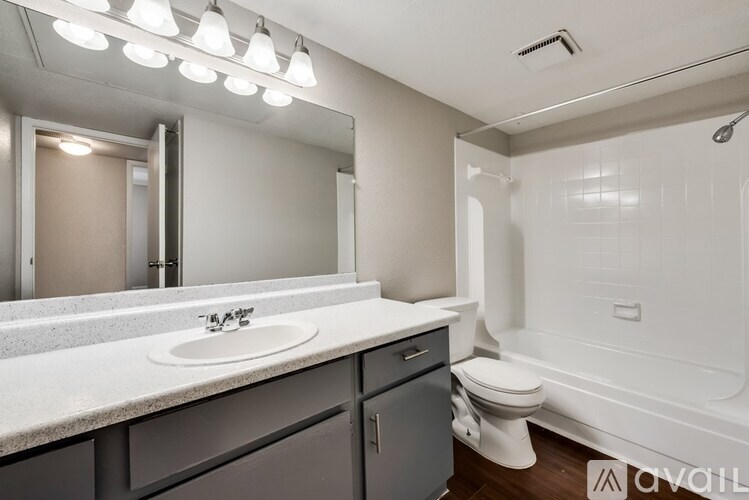 A bathroom with a sink, toilet, and bathtub.