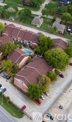 A bird's eye view of a residential area with houses and cars.