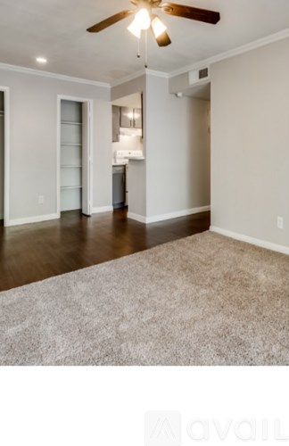 A room with a ceiling fan and a carpeted floor.