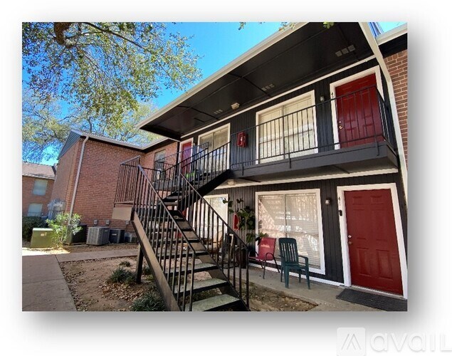 A house with a red door and a balcony with a red door.