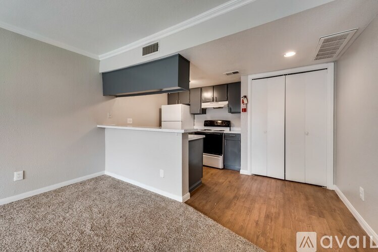 A kitchen area with a countertop and cabinets.
