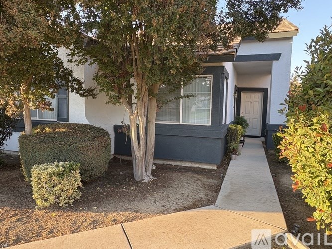 A room with a window and a fan on the ceiling.