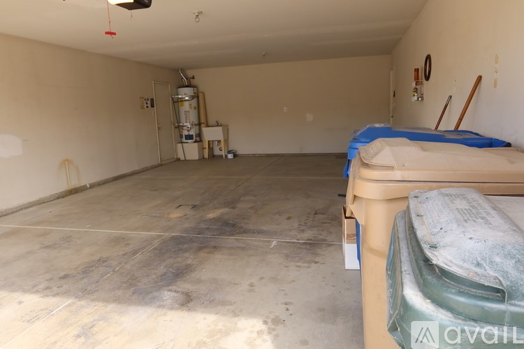 A large empty room with a bed on the right side.