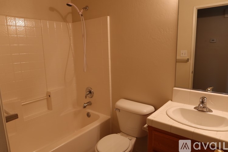 A bathroom with a toilet, sink, and bathtub.