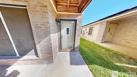 A house with a white door and a brick wall.