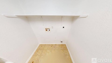 A room with a white ceiling and a wooden floor.