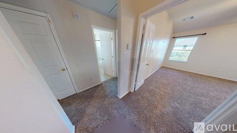 A room with a carpeted floor and white walls.