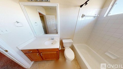 A bathroom with a toilet, sink, and bathtub.