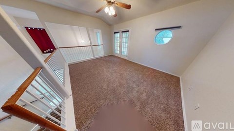 A room with a staircase leading to the upper floor.