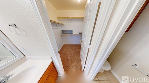 A small, narrow hallway with a carpeted floor and white walls.