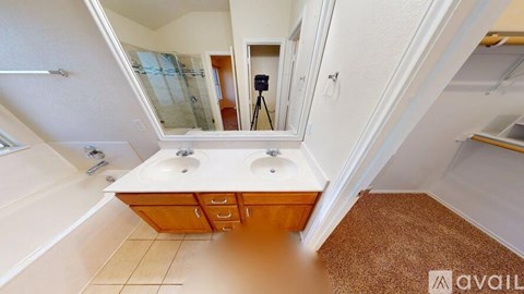 A bathroom with a large mirror and a sink.
