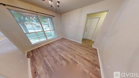 A room with wooden flooring and a skylight window.