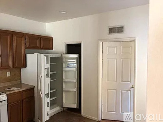 A kitchen with a refrigerator and oven in it.