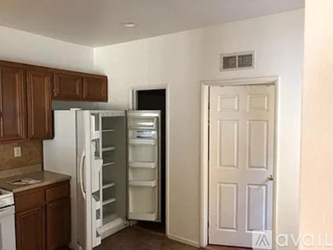 A kitchen with a refrigerator and oven in it.
