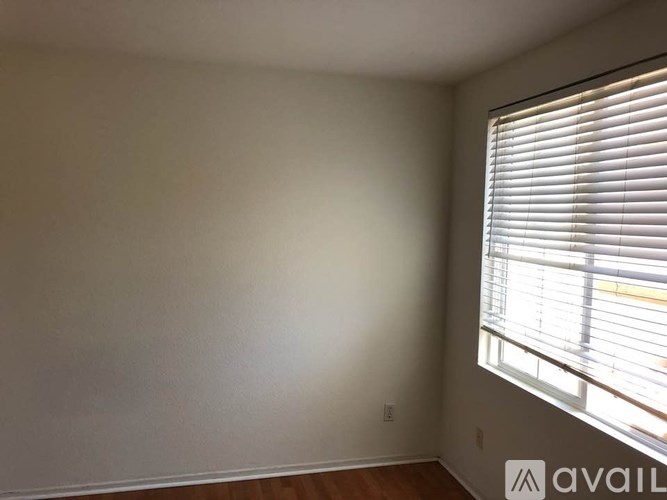A room with a window covered in blinds.