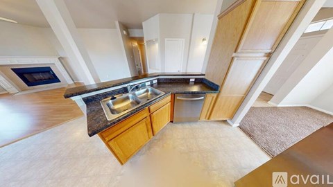 A kitchen with wooden cabinets and a granite countertop.