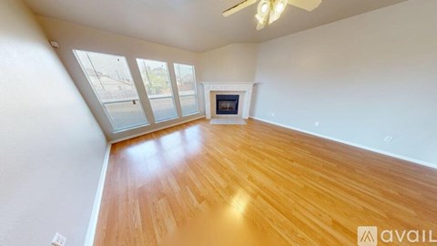 A room with wooden flooring and a fireplace is available for rent.