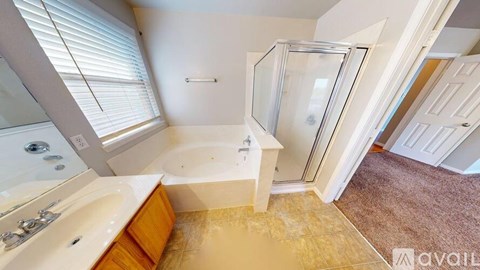 A bathroom with a tub, sink, and shower.