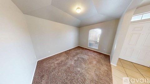 A room with a brown carpet and white walls.