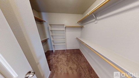 A small, empty room with a carpeted floor and white walls.