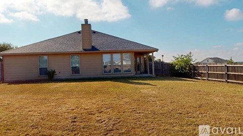 A house with a brown roof and a brown fence.