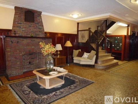 A living room with a brick fireplace and a wooden coffee table.
