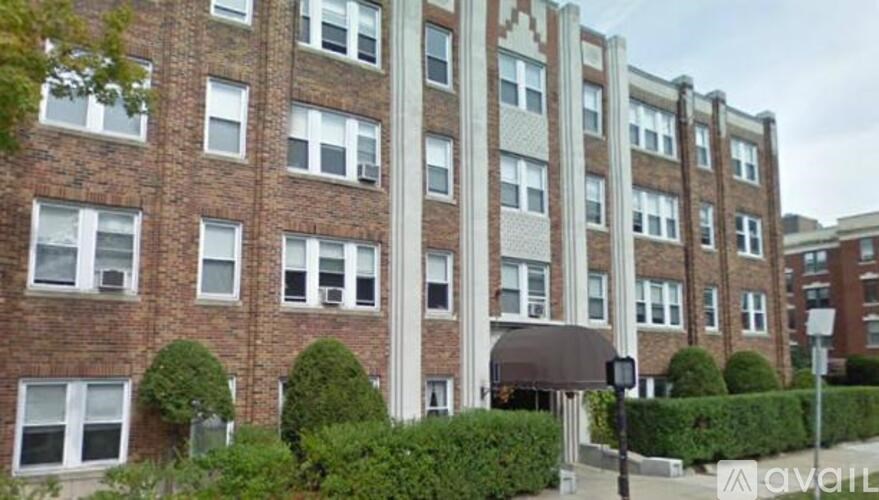 A tall brick building with white trim and windows.