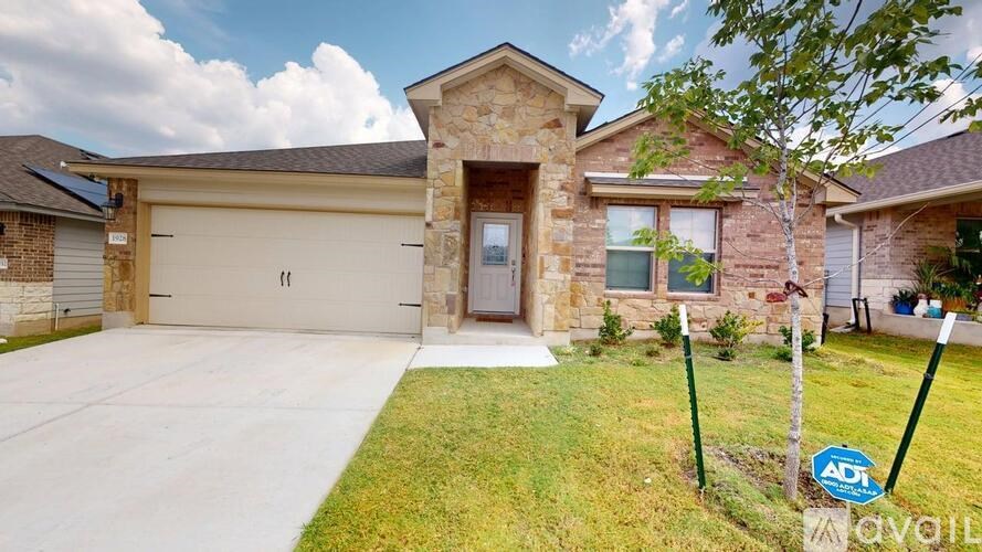 A house with a garage and a sign that says "available".
