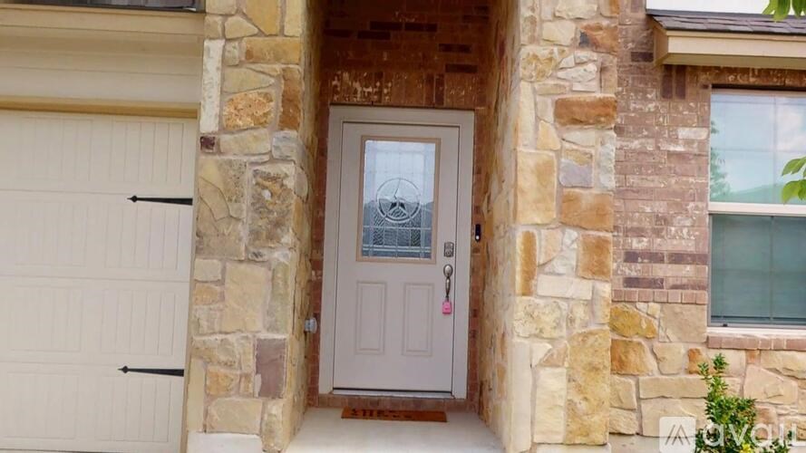 A house with a white door and a stone wall.