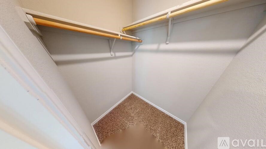 A white wall with a brown hexagonal object in the middle.