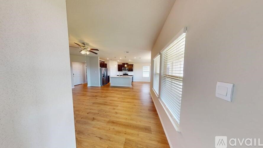 A room with wooden floors and a ceiling fan.
