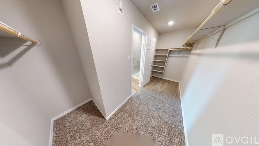 A stairway with a carpeted floor leads to a door.