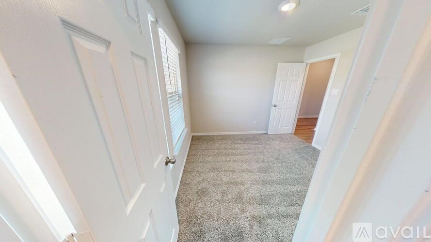 A room with white walls and a carpeted floor.
