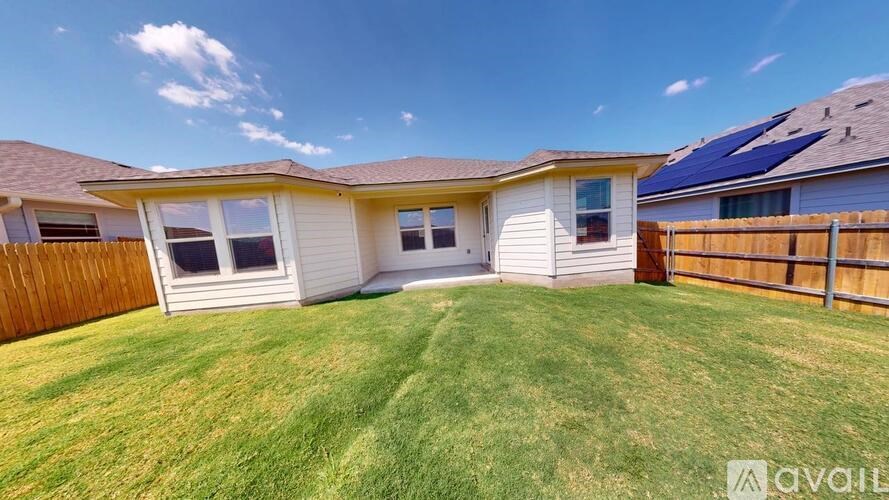 A house with a fence and a lawn is for sale.
