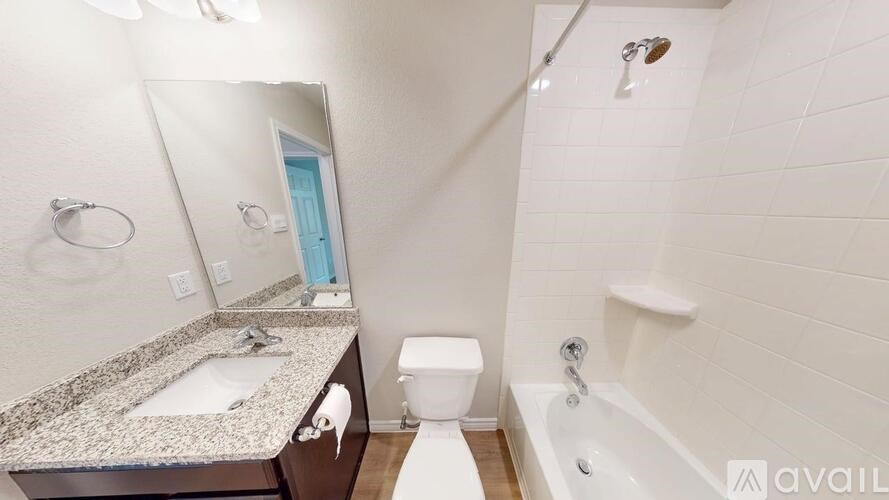 A bathroom with a sink, toilet, and bathtub.