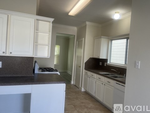 A kitchen with white cabinets and a countertop.