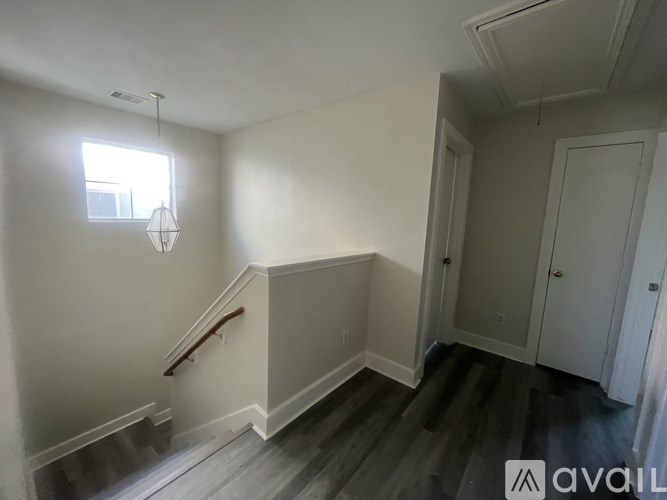 A room with a staircase and a window.