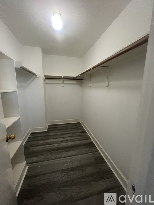 A hallway with a light on and a door on the left.