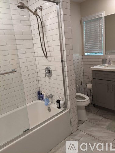 A bathroom with a white tub and a toilet.