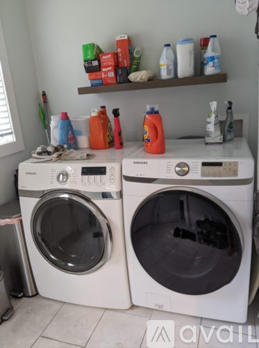 Two front loading washing machines in a laundry room.