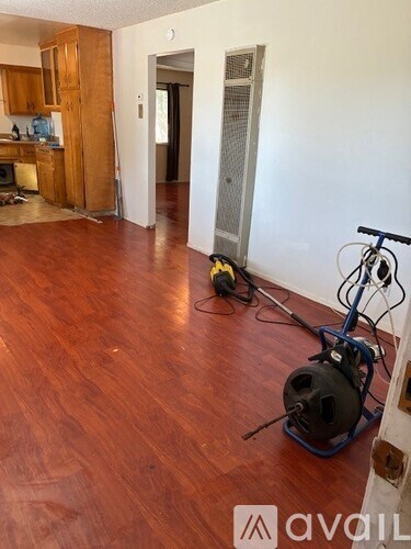 A room with wooden floors and a bicycle.