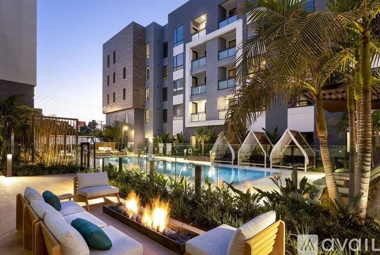 A poolside lounge area with a fire pit and seating area.