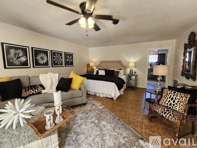 A bedroom with a bed, dresser, and mirror.