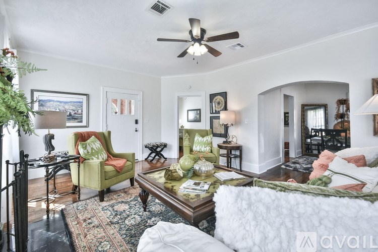 A living room with a green chair and a coffee table.
