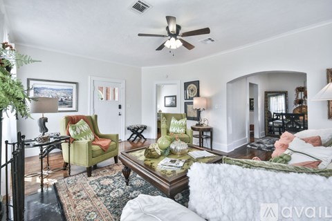 A living room with a green chair and a coffee table.