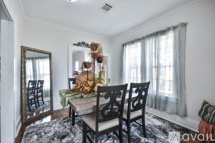 A dining room with a table set for a meal.
