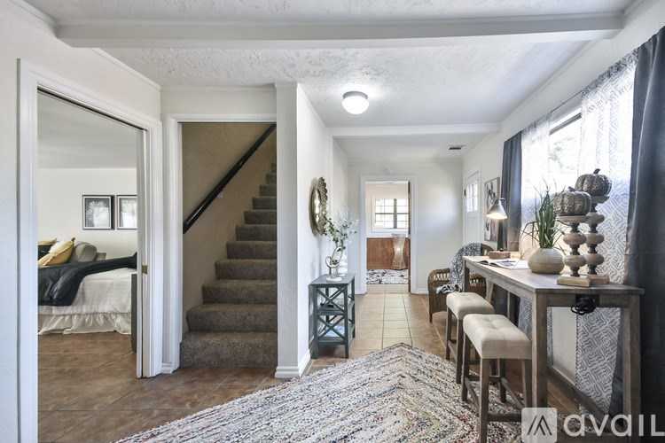 A living room with a staircase leading to the upper floor.