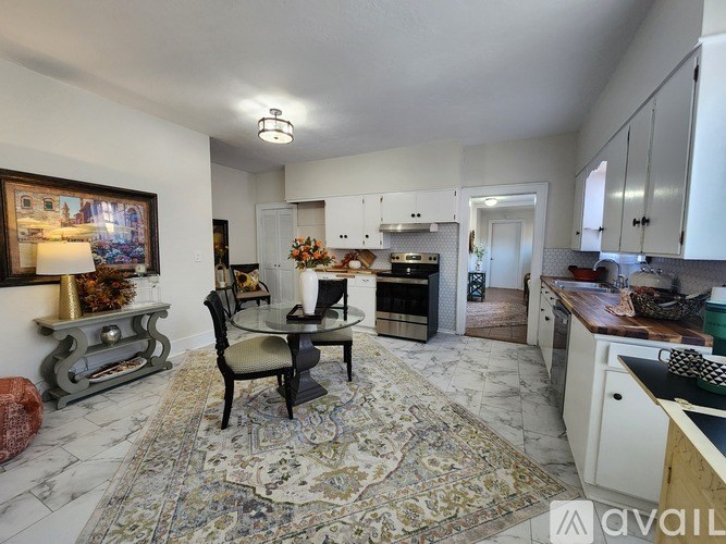 A kitchen with a table and chairs in the middle of the room.