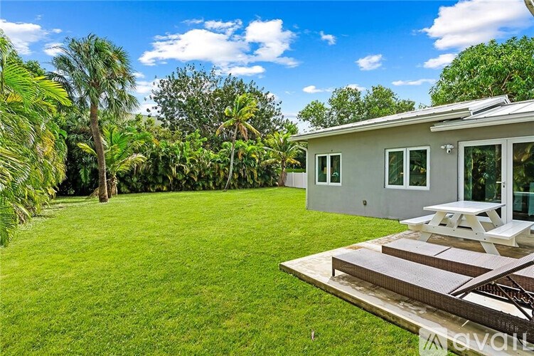A house with a backyard and a picnic table.